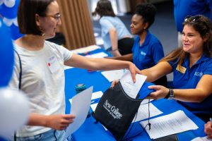 Student picking up information at an admissions event.