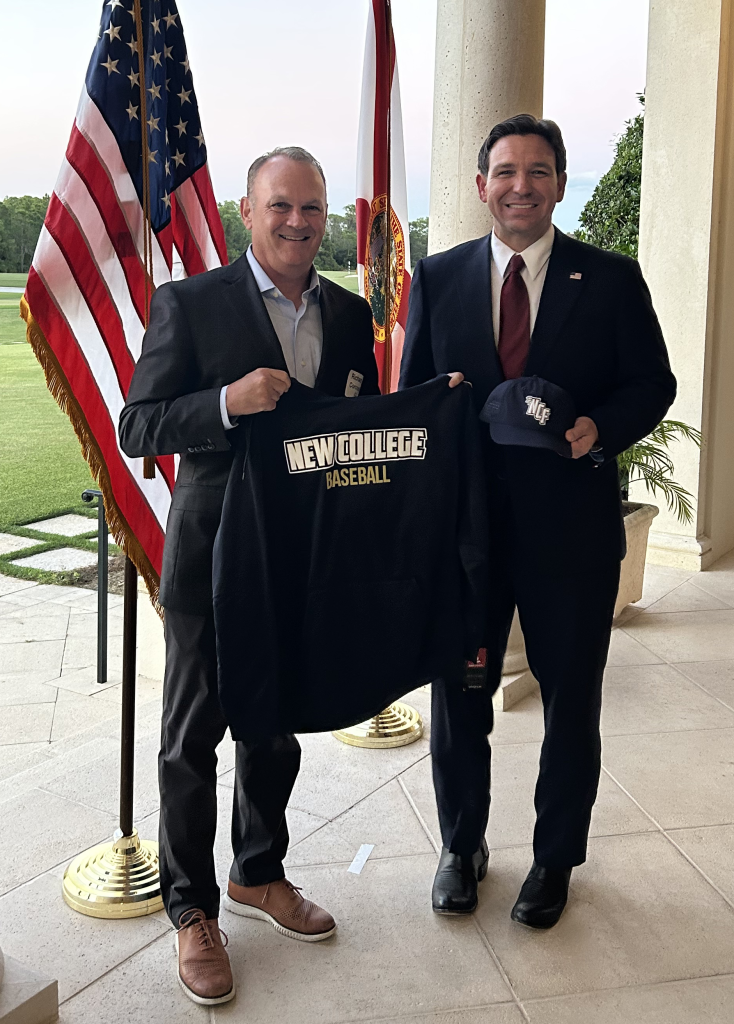 Richard Corcoran and Ron DeSantis demonstrate new Mighty Banyans baseball gear.