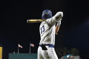NCF baseball player prepares to bat mid-game