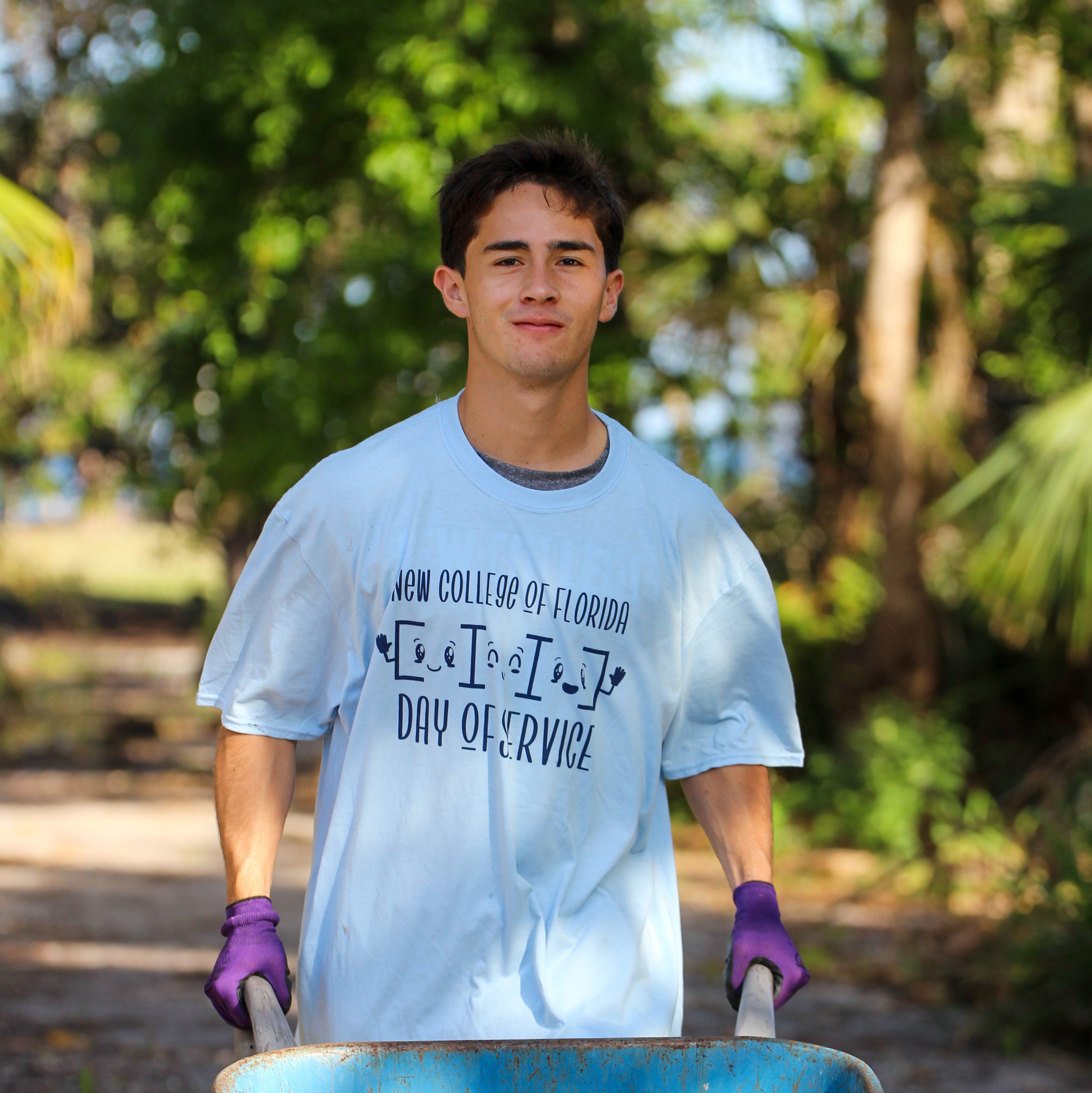 Student pushing a wheelbarrel