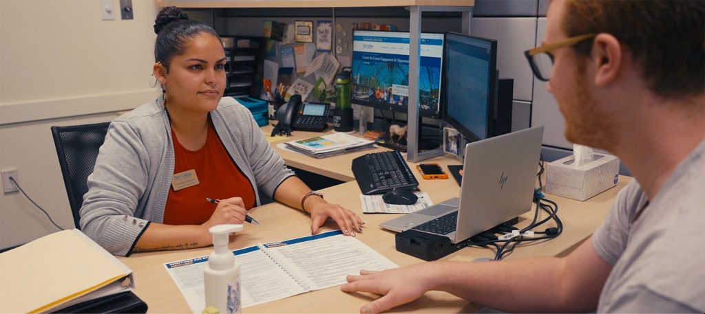 Academic Coach Advising student in office