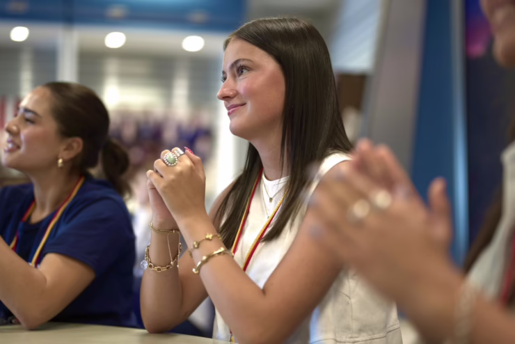 Student at a table listening attentively.