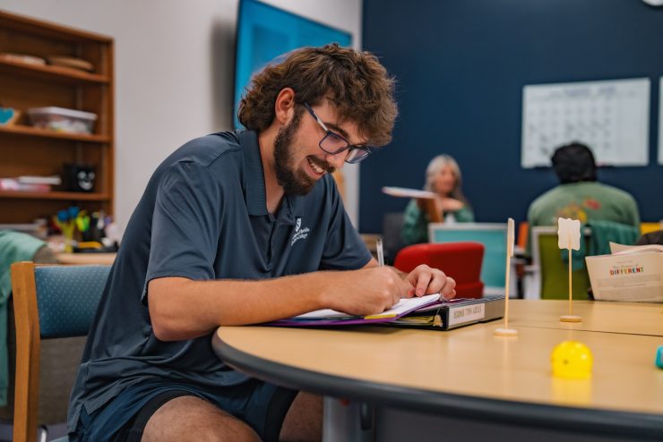 guy smiling doing homework in the ssc